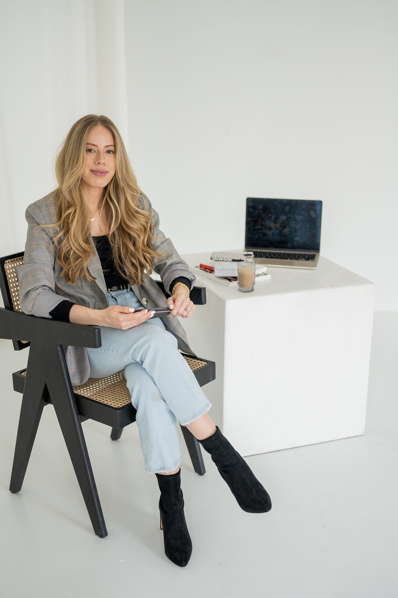 Saltd Studio’s owner, Emma Rodger, seated in a chair with a laptop behind her.